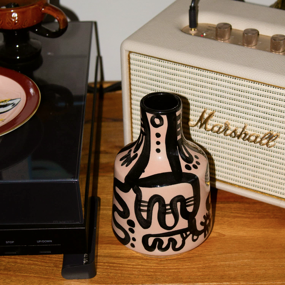 Patterned black and beige vase on table